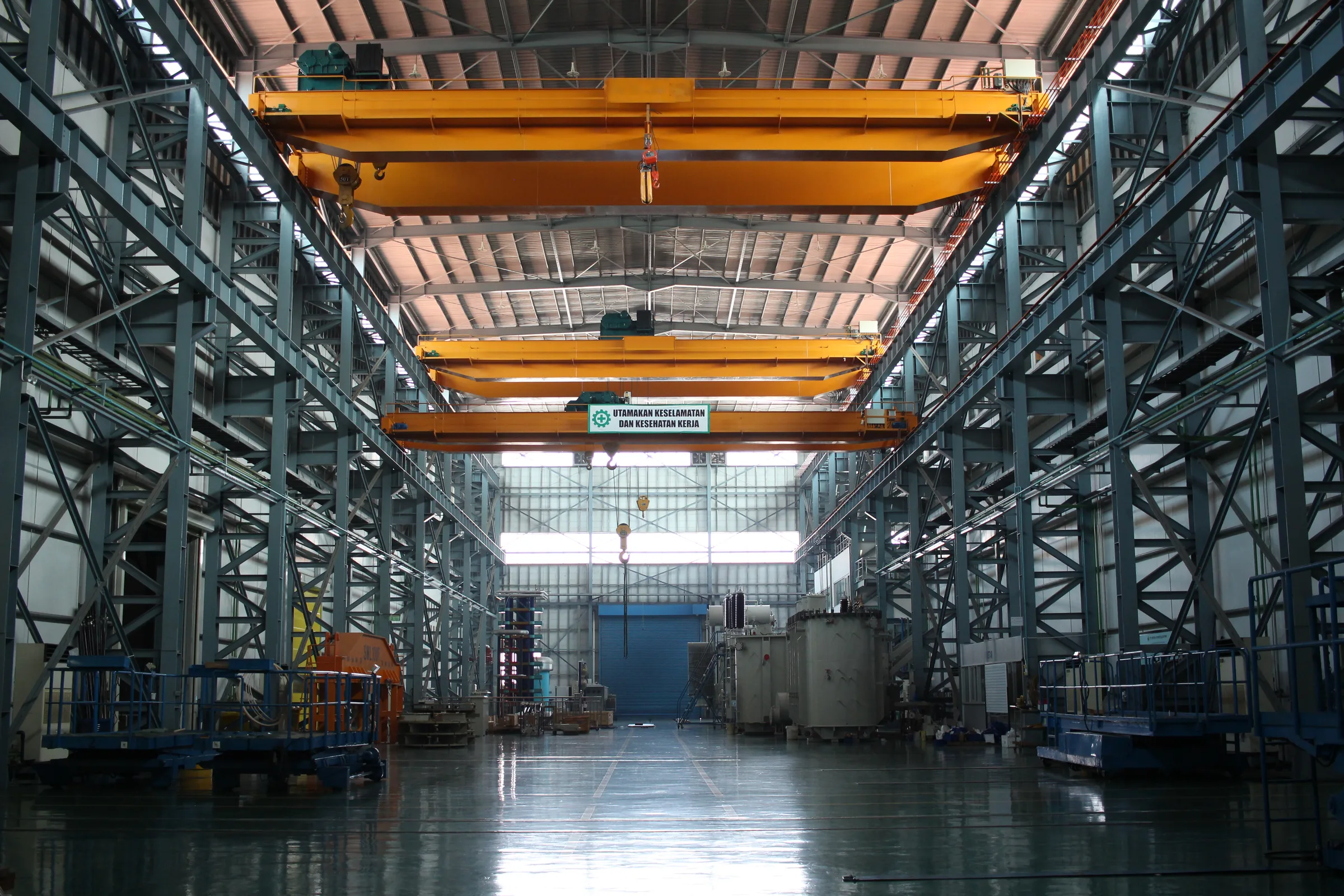 The 150 kV production hall in Lippo Cikarang, with overhead cranes above transformers in assembly