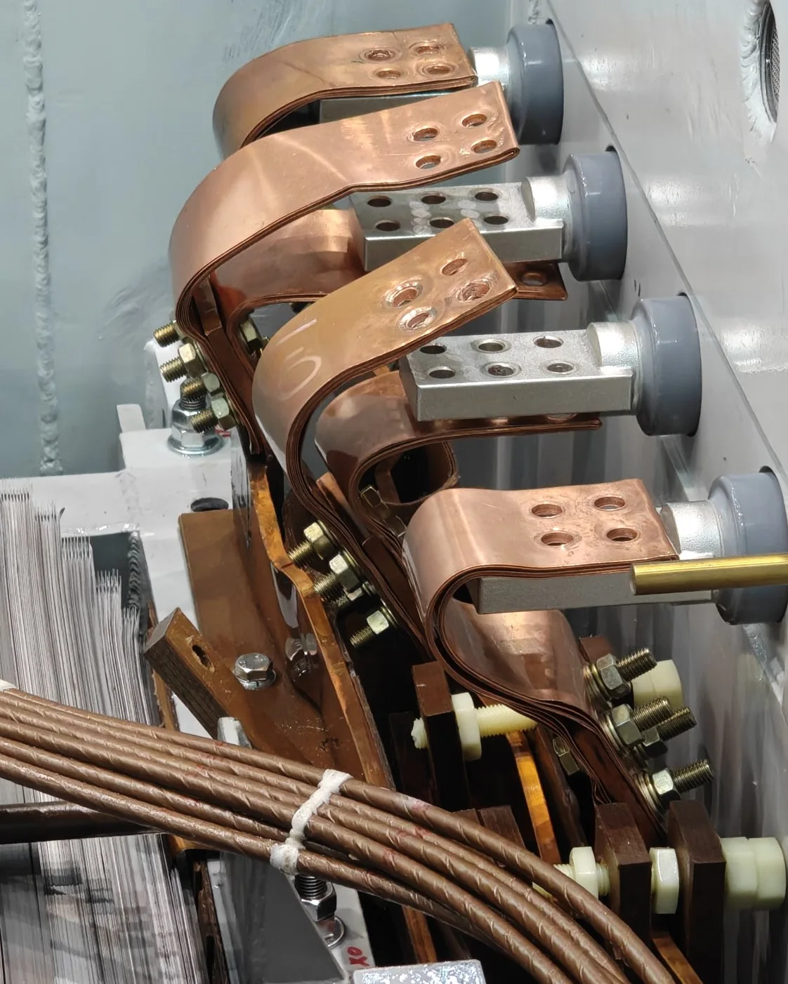 Copper lead connections to the bushings inside a transformer tank